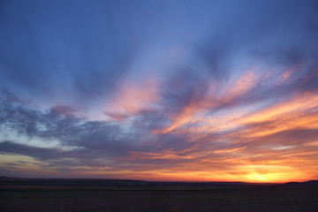 Fototapeta premium Dramatic sunset sky with orange colored clouds.