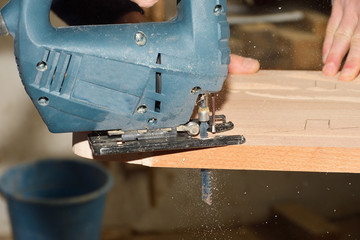 carpenter working with plane on wooden background