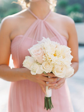Bridesmaid holding bouquet in pink dress 