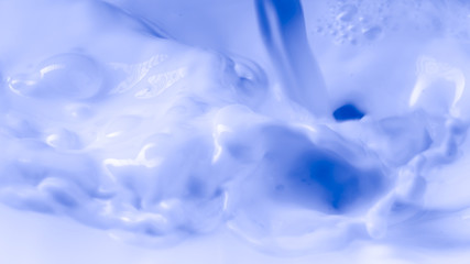 Photography liquid with the consistency of milk on blue