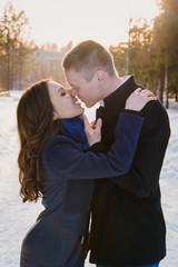 lovers kiss in the park in the winter