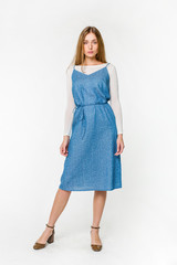 Young elegant female in light summer dress, over white background