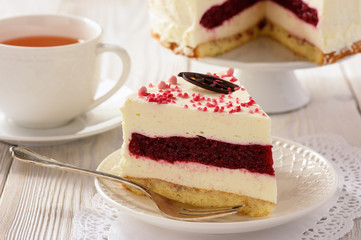 Homemade biscuit cake with cherry jelly and cream.