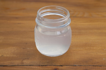 jar of Lemonade in a wooden background.