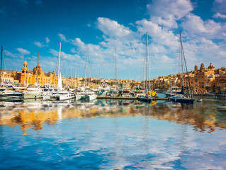 yachts near pier in Birgu near Cospicua in Malta with reflection