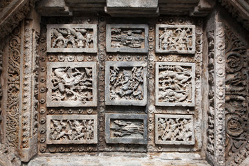 Dancing people, and Ganesh with Shiva lord. Carvings on stone ceiling of 12th century temple Hoysaleswara, India. Temple was built in 1150 by king of Hoysala Empire, now Karnataka state.