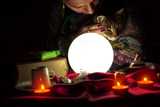 Fortuneteller with crystal ball and cat