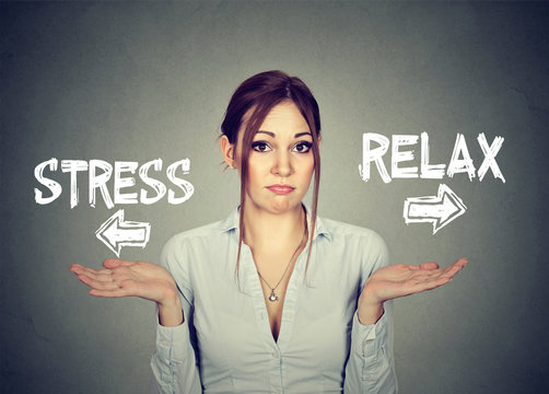 Stress or relax. Confused woman shrugging shoulders doesn't know