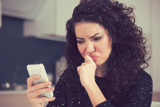 Upset Confused Young Woman Suing Mobile Phone Reading Text Message