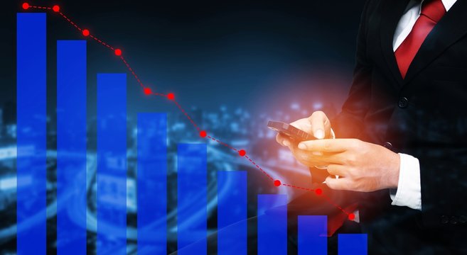 double exposure of businessman using his tablet with trading graph on blurred night city background, business and broker financial concept, color tone effect.