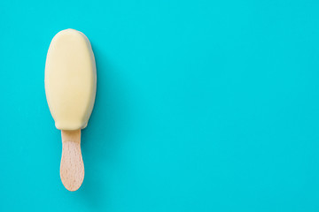 White chocolate ice cream popsicles on blue background. 
