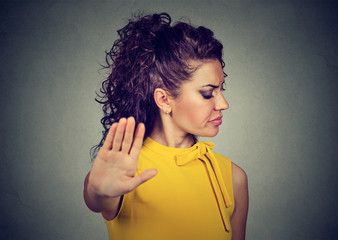 annoyed angry woman with bad attitude giving talk to hand gesture