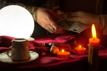 Fortune teller woman receive money for fortune telling