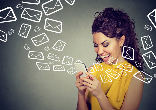 Woman busy sending messages on smart phone email icons flying out