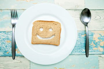 Toast with a smile on plate for breakfast