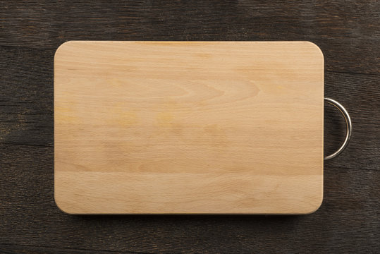 Chopping board on wooden background