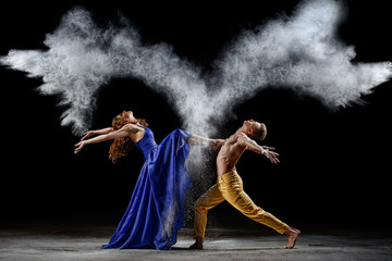 Dance duet with the powder mixtures in the dark. - obrazy, fototapety, plakaty