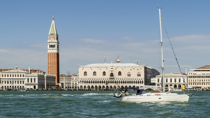 Sailing with a beautiful luxury catamaran on the Venetian lagoon with Piazza San Marco in the background, Venice, Italy