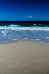 A simple vertical photo of a tropical beach and the ocean. New Providence, Nassau, Bahamas.