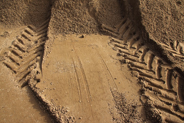 Fototapeta premium Wheel tractor trace on the freshly transported river sand