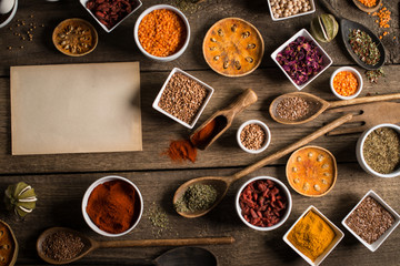 Various colorful spices on wooden table. Place for typography and logo
