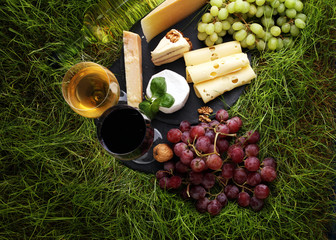 Cheese platter and wine with different cheese and grapes