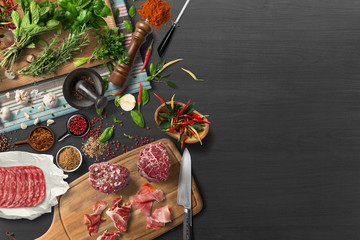 Overhead view of colorful roast vegetables, savory sauces and salt served with grilled t-bone steak...