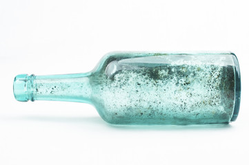 Sea blue bottle found along the beach, white background, horizontal