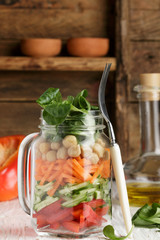 Healthy homemade Mason Jar salad with chickpeas and vegetables - cucumber, carrot, bell pepper, lettuce corn. Healthy eating, diet, detox. Selective focus