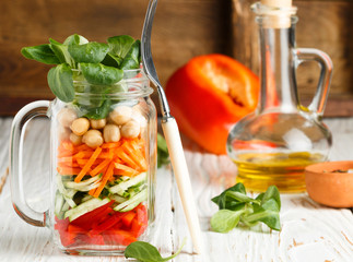 Healthy homemade Mason Jar salad with chickpeas and vegetables - cucumber, carrot, bell pepper, lettuce corn. Healthy eating, diet, detox. Selective focus