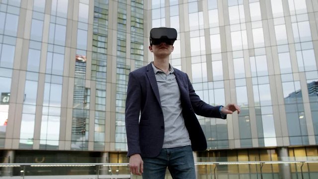 caucasian man Using Virtual Reality outside