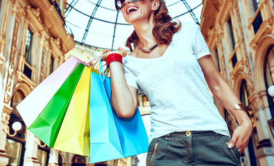 Smiling woman with shopping bags in Galleria Vittorio Emanuele