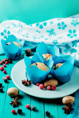 Sweet pastries, berry muffins with blueberries and raspberries on a wooden background