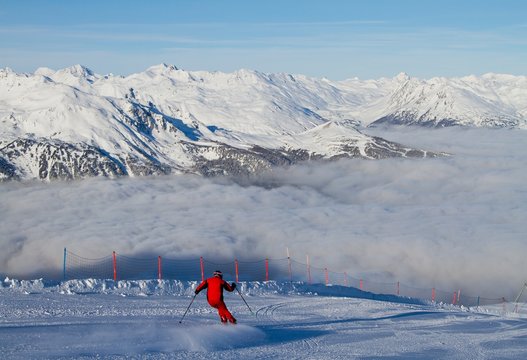 Europe, Italy, Lombardy, Sondrio. Ski on the slopes that lead to the Bormio 3000 Cimino, above a sea of clouds