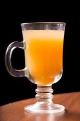 Glass glass with mango juice on a black background