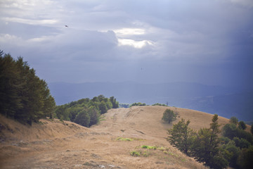 Mountain view, hiking through the mountains, panorama. Summer hiking trip. Sky, clouds and nature in the highlands, hiking trails.