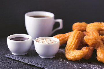 Traditional Spanish dessert churros with hot chocolate and coffee
