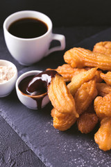 Traditional Spanish dessert churros with hot chocolate and coffee