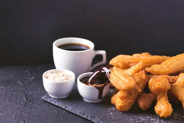 Traditional Spanish dessert churros with hot chocolate and coffee