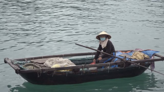 A woman fish came ashore to sell fish caught in the sea. Vietnam, Asia. 4K