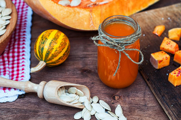Pumpkin juice in a glass jar with raw seeds in the shell