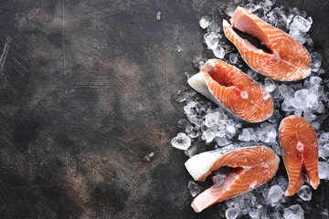 Steaks of raw salmon on ice.Top view with space for text.
