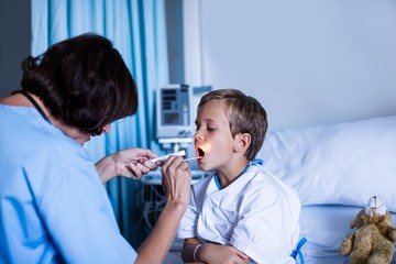 Female doctor examining patient mouth