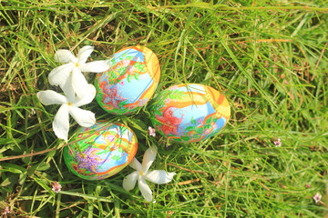 Painted Easter eggs hidden on the grass, ready for the easter egg hunt traditional play game
