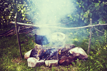 Cooking in a hiking trip, eating in the mountains, tourism. Cooking at the stake.