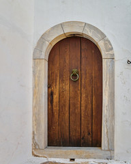solid wood brown door on white wall