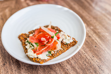 Macro closeup of healthy onion appetizer on chia flatbread toast and cheese