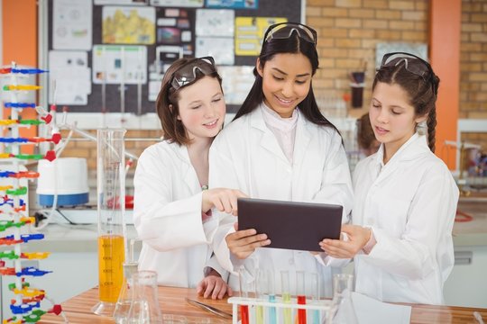 School girls using digital tablet in laboratory