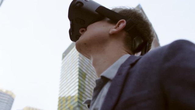 close up of caucasian man Using Virtual Reality outside