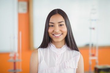 Portrait of smiling schoolgirl in classroom